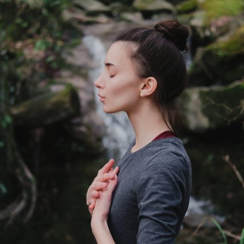Young,Woman,Practicing,Breathing,Yoga,Pranayama,Outdoors,In,Moss,Forest